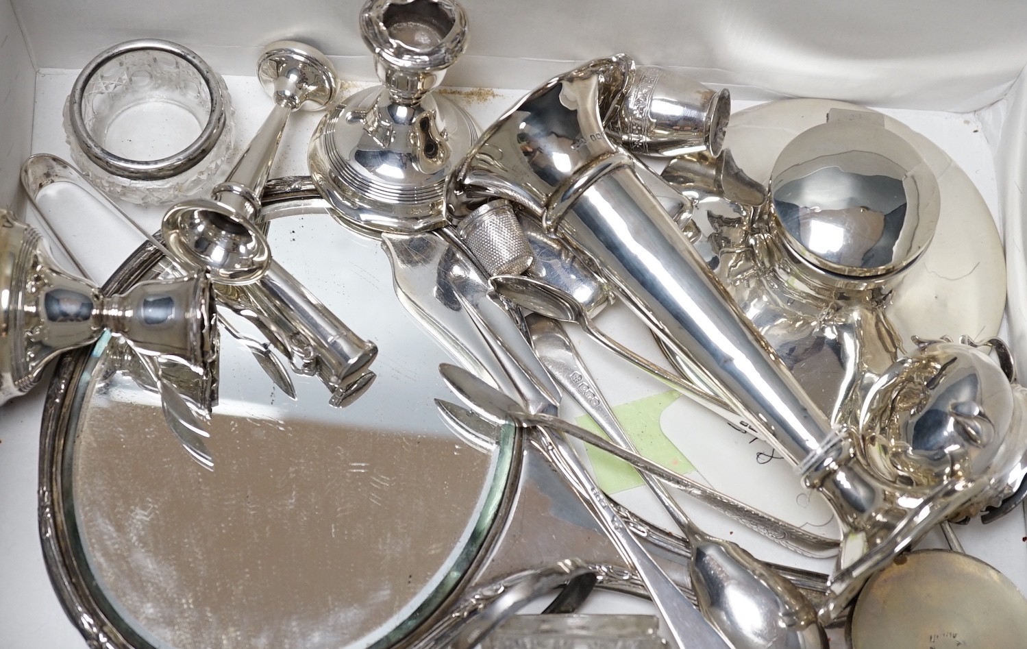 Sundry small silver items including a hand mirror, capstan inkwell, flatware, vesta case, mounted glass salts, dwarf candlesticks, condiments, posy vase, etc.